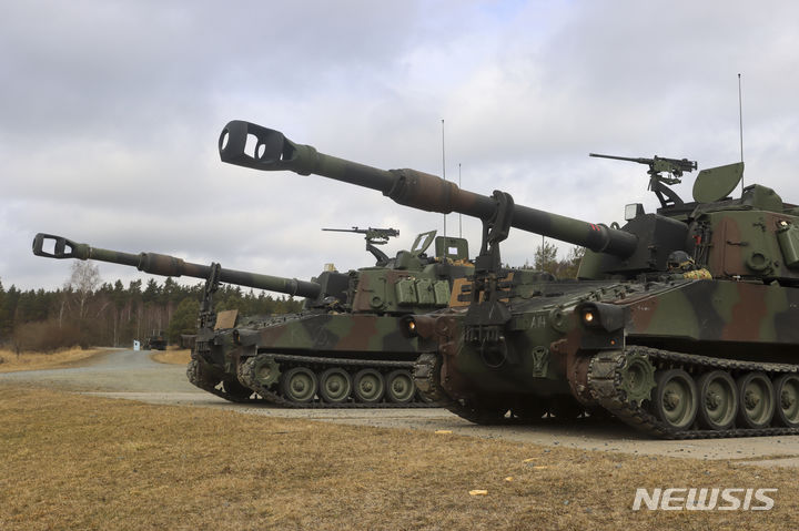[그라펜뵈르=AP/뉴시스] 미국이 새로운 국방 전략에 따라 중국 견제에 집중하기 위해 유럽 주둔 미군을 감축할 수 있다고 외신이 26일(현지 시간) 보도했다. 사진은 2022년 3월 독일 그라펜뵈르 미 육군 기지에서 미군이 M109 팔라딘 자주포 실사격 시범을 보이고 있는 모습. 2025.05.27.