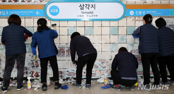 [서울=뉴시스] 백동현 기자 = 서울교통공사 청소노동자들이 27일 오전 서울 용산구 삼각지역 승강장에서 전국장애인차별철폐연대(전장연)의 불법 전단물을 제거하고 있다. 2023.02.27. livertrent@newsis.com