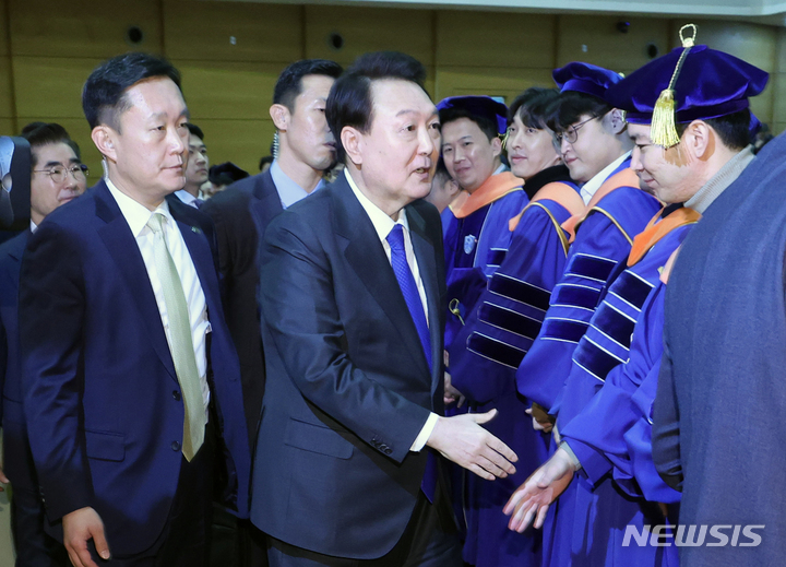[서울=뉴시스] 홍효식 기자 = 윤석열 대통령이 27일 서울 서대문구 연세대학교에서 열린 2023년 2월 학위수여식에서 축사를 마친 뒤 졸업생들과 악수하고 있다. (대통령실통신사진기자단) 2023.02.27. yesphoto@newsis.com