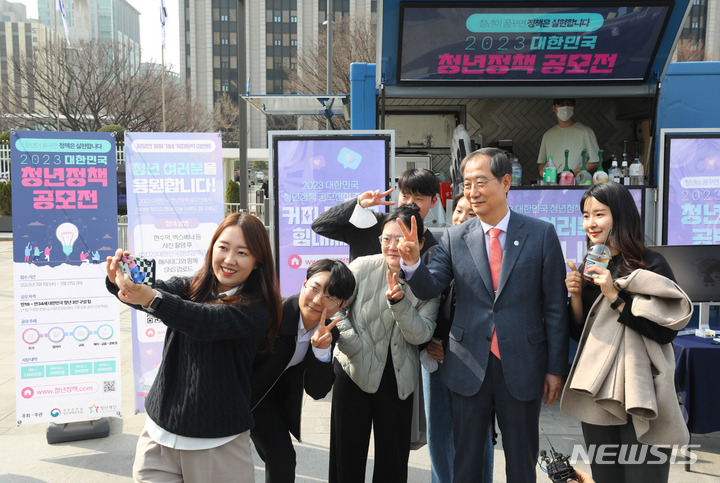 [서울=뉴시스] 배훈식 기자 = 한덕수 국무총리가 10일 오후 서울 종로구 정부서울청사 앞에서 청년정책 공모전 홍보 부스를 격려 방문해 청년들과 셀카를 찍고 있다. 2023.03.10. dahora83@newsis.com
