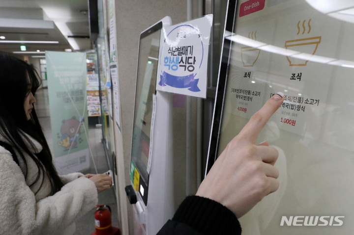 [서울=뉴시스] 백동현 기자 = 13일 오전 서울 동대문구 경희대학교 푸른솔문화관 식당에서 학생들이 키오스크를 통해 조식을 결제하고 있다. 경희대는 이날부터 학생들이 1000원으로 아침식사를 할 수 있는 '푸른솔 식당 천원의 아침밥' 운영을 시작한다고 밝혔다. 2023.03.13. livertrent@newsis.com