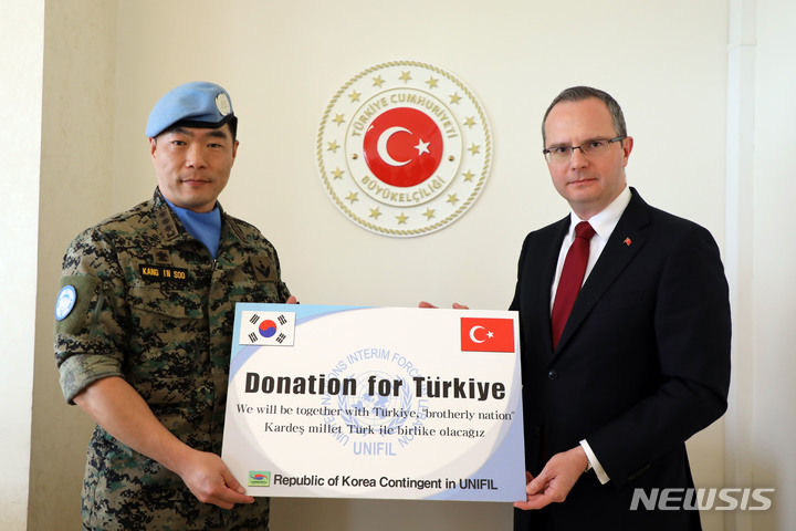 [서울=뉴시스] 동명부대장 강인수 대령이 알리 레바논 튀르키예 대사에게 성금을 전달하고 있다. (사진=합동참모본부 제공) 2023.03.19