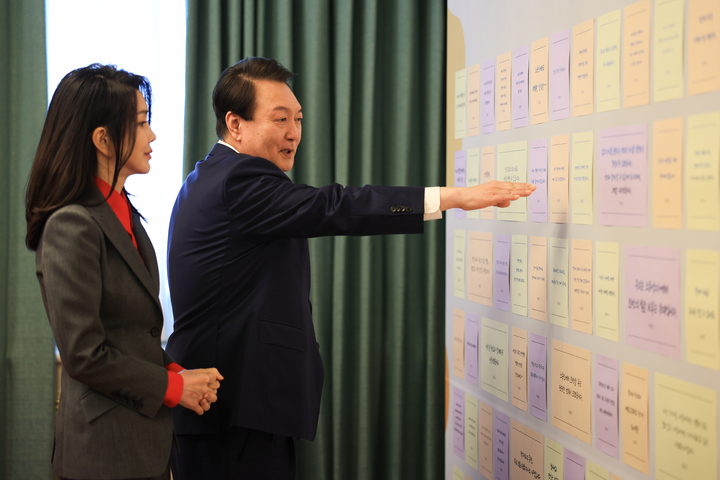 [서울=뉴시스] 윤석열 대통령과 부인 김건희 여사가 23일 청와대 영빈관에서 열린 복지·노동 현장 종사자 초청 오찬에서 현장 종사자들의 희망과 바람이 담긴 메시지를 살펴보고 있다. (사진=대통령실 제공) 2023.03.23. photo@newsis.com *재판매 및 DB 금지