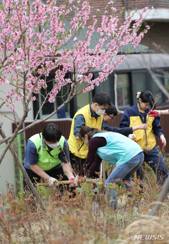 [서울=뉴시스] 김금보 기자 = 식목일을 하루 앞둔 4일 오전 서울 용산구 효창공원앞역 광장에서 봉사자들이 수목 식재 봉사활동을 하고 있다. 이날 봉사활동에는 용산구 소재 민·관·학 연합 봉사체 '용산 드레곤즈' 소속 봉사자들이 참여했다. 2023.04.04. kgb@newsis.com