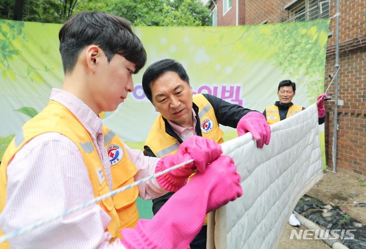 [서울=뉴시스] 김진아 기자 = 김기현 국민의힘 대표가 12일 오전 서울 성동구 아동 복지시설인 '이든 아이빌'을 찾아 봄맞이 빨래 봉사 활동을 하고 있다. 2023.05.12. bluesoda@newsis.com