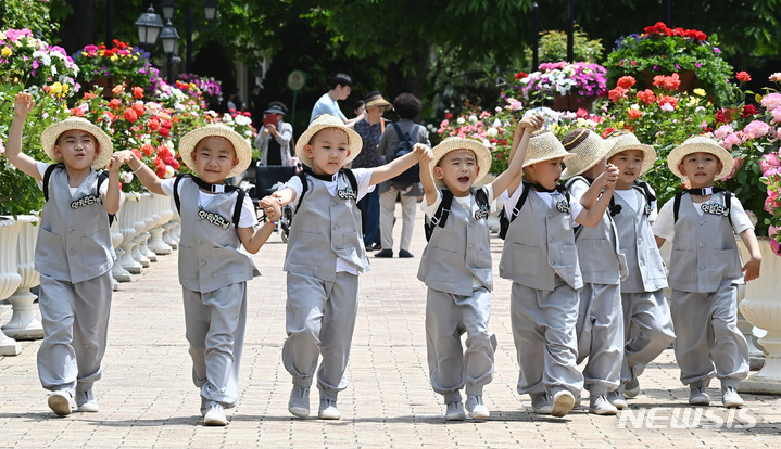 [용인=뉴시스] 김종택 기자 = 석가탄신일을 열흘 앞둔 17일 경기도 용인 에버랜드 장미원을 찾은 조계사 단기 출가 동자승들이 달리기를 하며 즐거워하고 있다. 2023.05.17. jtk@newsis.com