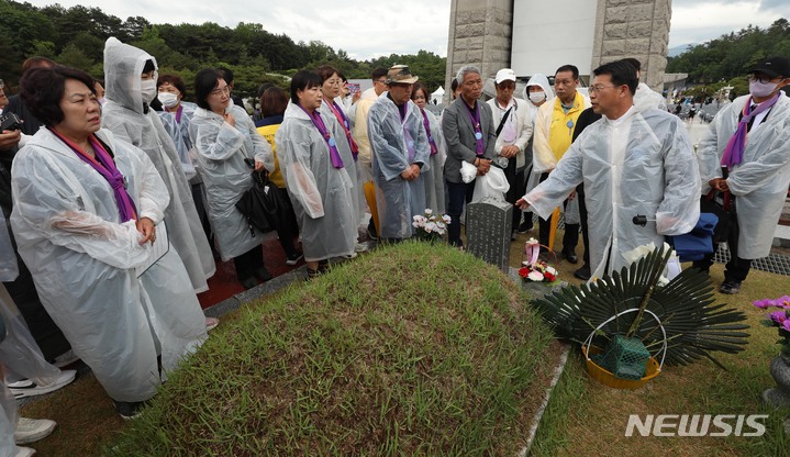 [광주=뉴시스] 김혜인 기자 = 5·18 민주화운동 43주년 기념식이 열린 18일 광주 북구 국립 5·18민주묘지에서 이태원 참사 유가족들이 묘소를 참배하고 있다. (공동취재사진) 2023.05.18. photo@newsis.com