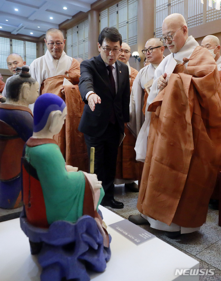 [서울=뉴시스] 최동준 기자 = 23일 서울 종로구 조계사에서 열린 도난 성보 환수 고불식에서 조계종 총무원장 진우스님, 최응천 문화재청 청장 등 참석자들이 전주 서고사 목조나한좌상을 살펴보고 있다. 2023.05.23. photocdj@newsis.com