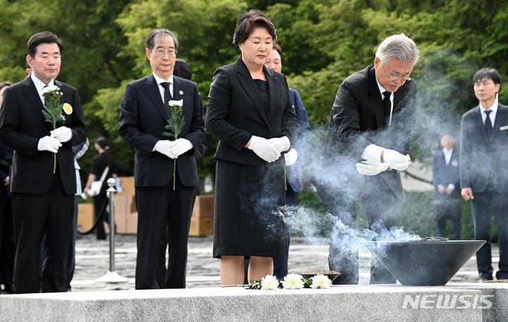 [김해=뉴시스] 차용현 기자 = 문재인 전 대통령과 부인 김정숙 여사가 23일 경남 김해시 봉하마을에서 열린 노무현 전 대통령 서거 14주기 추도식에서 묘역을 참배하고 있다. (공동취재사진) 2023.05.23. photo@newsis.com