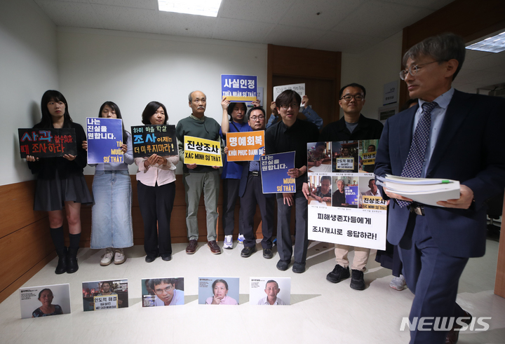 [서울=뉴시스] 고승민 기자 = '베트남전쟁 문제의 정의로운 해결을 위한 시민사회네트워크' 회원들이 24일 서울 중구 진실화해를 위한 과거사 정리위원회 회의실 앞에서 베트남전 '하미학살' 조사 개시를 촉구하는 피켓팅을 하고 있다. 그 앞으로 김광동 진실화해위원장이 지나가고 있다. 2023.05.24. kkssmm99@newsis.com