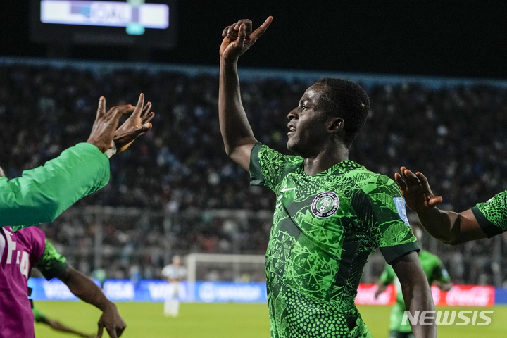 Nigeria's Rilwanu Haliru Sarki, center, celebrates after scoring his side's 2nd goal against Argentina during a FIFA U-20 World Cup round of 16 soccer match at the Bicentenario stadium in San Juan, Argentina, Wednesday, May 31, 2023. (AP Photo/Ricardo Mazalan)