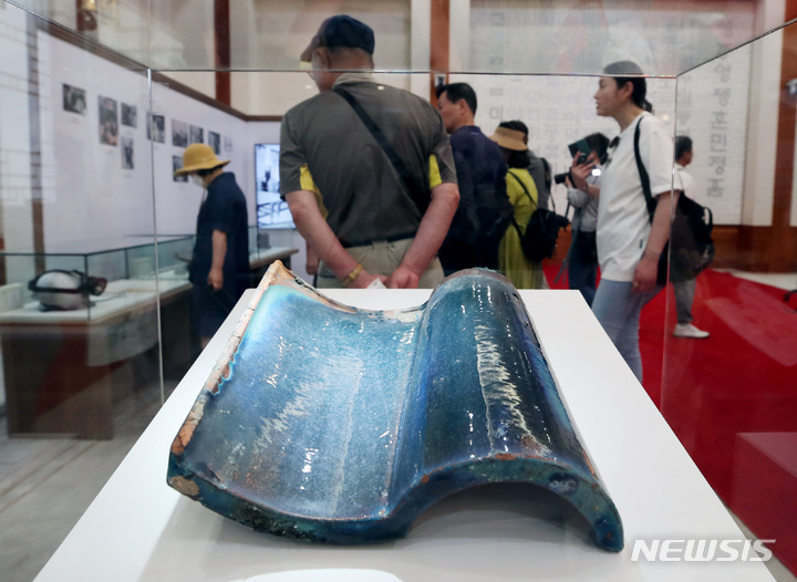 [서울=뉴시스] 김진아 기자 = 1일 서울 종로구 청와대 본관에서 열린 청와대 개방 1주년 기념 특별전시 '우리 대통령들의 이야기-여기 대통령들이 있었다'에서 관람객들이 윤보선 전 대통령 시절 청와대 청기와 등 전시품을 살펴보고 있다. 문화체육관광부가 오는 8월28일까지 청와대 본관과 춘추관에서 진행하는 이번 전시에서는 대통령들의 삶의 기록을 담은 다채로운 소품과 자료들이 공개된다. 2023.06.01. bluesoda@newsis.com