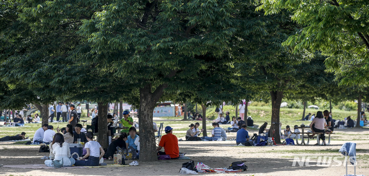 [서울=뉴시스] 정병혁 기자 = 6일 오후 서울 영등포구 여의도한강공원을 찾은 시민들이 그늘에서 즐거운 시간을 보내고 있다. 2023.06.06. jhope@newsis.com