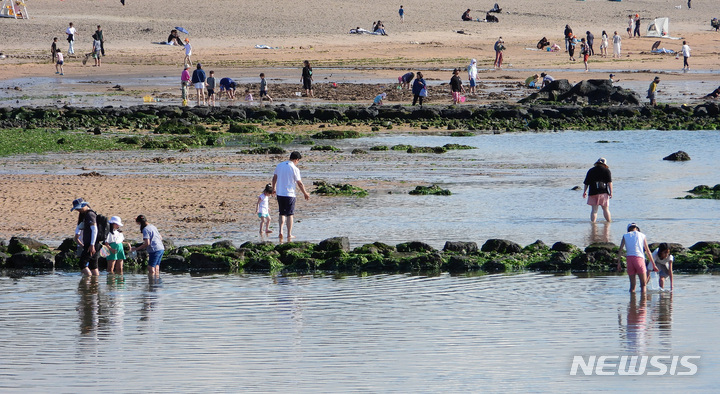 [제주=뉴시스] 우장호 기자 = 제주시 이호해수욕장을 찾은 도민과 나들이객들이 바닷물에 발을 담그며 즐거운 시간을 보내고 있다. 2023.06.06. woo1223@newsis.com