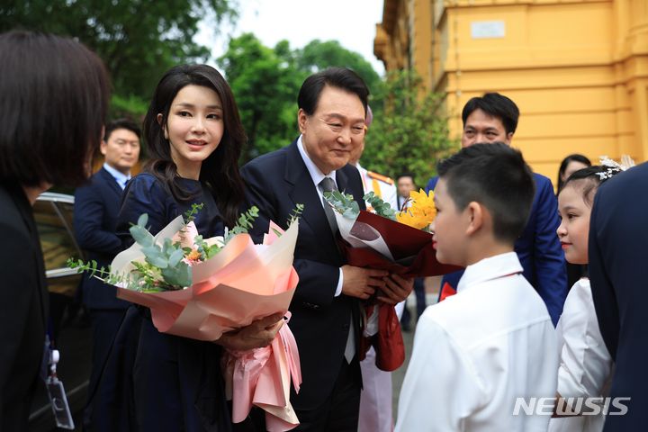 [하노이=뉴시스] 전신 기자 = 베트남을 국빈 방문한 윤석열 대통령 부인 김건희 여사가 23일(현지시간) 하노이 베트남 주석궁 대정원에서 열린 공식환영식에서 화동으로부터 꽃다발을 받고 있다. (공동취재) 2023.06.23. photo1006@newsis.com