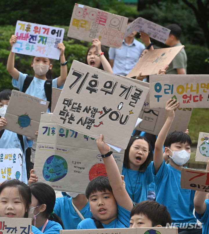 [수원=뉴시스] 김종택 기자 = 5일 경기도 수원시 권선구 올림픽공원에서 신영초등학교 학생들이 수원환경운동연합, 다산인권센터와 함께 기후위기 대응을 촉구하는 퍼포먼스를 하고 있다. 2023.07.05. jtk@newsis.com