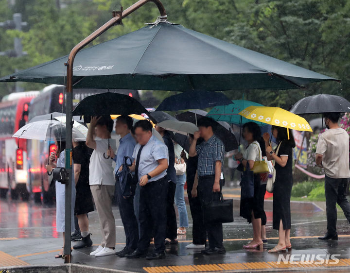 [서울=뉴시스] 김명년 기자 = 서울 동북권과 서북권에 호우주의보가 내려지면서 최대 150㎜ 이상의 비가 내릴 전망이다. 사진은 11일 오전 서울 광화문 네거리에서 우산을 쓴 시민들이 건널목 신호가 바뀌기를 기다리고 있는 모습. 2023.07.11. kmn@newsis.com