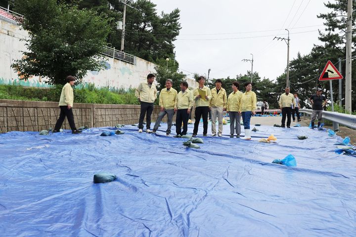 [고성(경남)=뉴시스] 신정철 기자= 경남 고성군의회 최을석 의장과 의원들은 지난 17일 지방도 1010호선 일부 도로가 유실된 삼산면 두포리 군령포 현장을 찾아 피해 상황을 점검하고 추가적인 위험 요소가 없는지 살펴보고 있다.(사진=고성군의회 제공).2023.07.18. photo@newsis.com *재판매 및 DB 금지