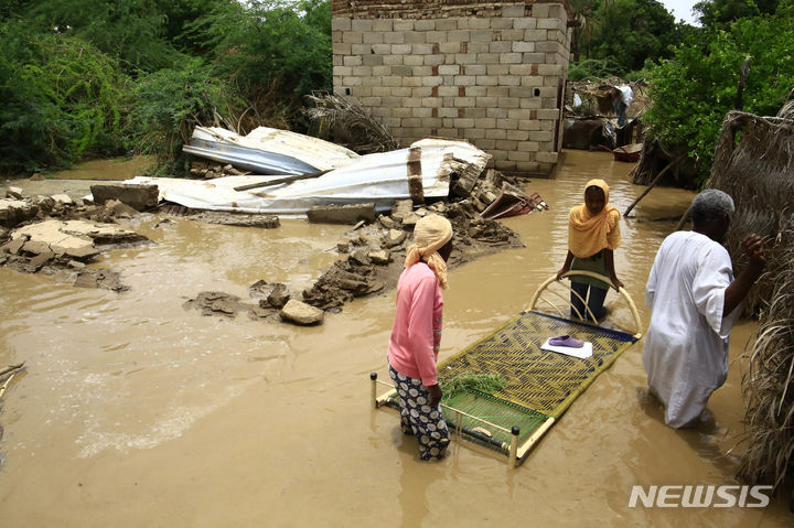[ 카살라( 수단)=신화/뉴시스] 수단 동부의 카살라 마을에서 4일 폭우로 침수를 겪은 주민들이 가구를 옮기고 있다.&nbsp; 수도 하르툼 일대에서는 주말부터 정부군과 반군 RSF군이 격전을 벌여 수많은 사람들이 피난길에 올랐다. 재해 속에서도 전투는 계속된다.&nbsp; 2023.08.08. 