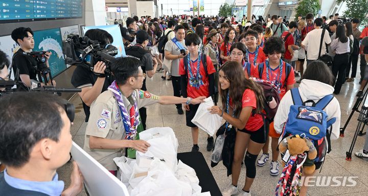 [서울=뉴시스] 공항사진기자단 = 2023 제25회 세계 스카우트 잼버리가 마무리된 12일 오전 인천국제공항 제1터미널에서 세계스카우트 잼버리 대원들이 출국 전 선물을 받고 있다. 2023.08.12. photo@newsis.com