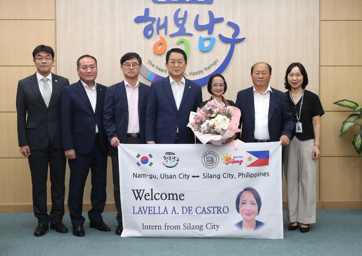 [울산=뉴시스] 박수지 기자 =서동욱 울산 남구청장이 18일 구청장실에서 우호교류도시 필리핀 실랑시 파견 공무원 라벨라 디 카스트로 씨(오른쪽 세 번째)에게 환영 꽃다발을 전달한 뒤 간부공무원들과 기념촬영을 하고 있다. 2023.08.18. (사진=남구 제공) photo@newsis.com *재판매 및 DB 금지