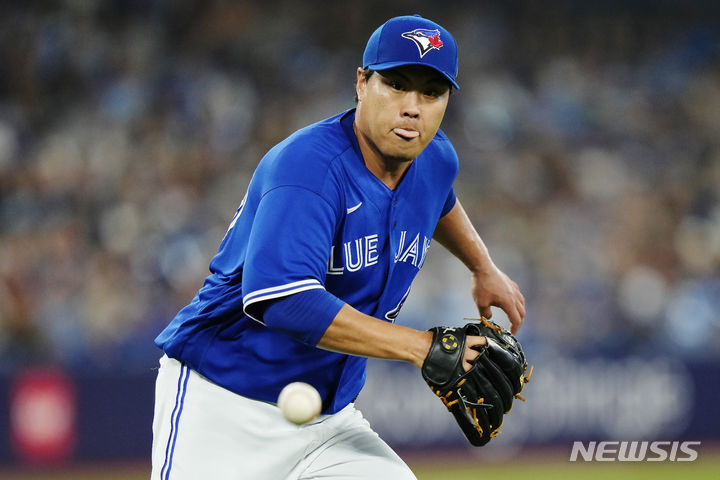 Toronto Blue Jays starting pitcher Hyun Jin Ryu (99) fields a ball off the bat of Cleveland Guardians' Tyler Freeman during the second inning of a baseball game in Toronto on Saturday, Aug. 26, 2023. (Frank Gunn/The Canadian Press via AP)