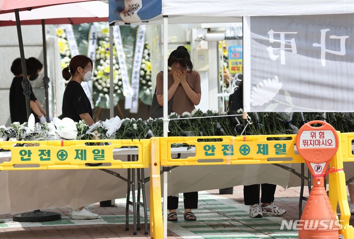 [서울=뉴시스] 고승민 기자 = 지난달 31일 서울, 전북교육청 소속 초등교사 A, B씨 2명이 극단 선택을 한 가운데 3일 A씨가 재직했던 서울 양천구의 한 초등학교에서 추모객이 눈물을 훔치고 있다. 2023.09.03. kkssmm99@newsis.com