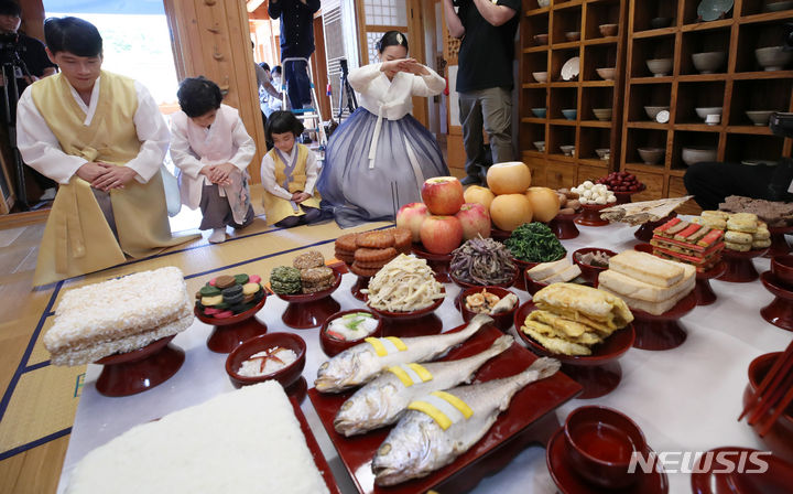 [서울=뉴시스] 조성우 기자 = 22일 오전 서울 은평구 은평한옥마을 예서헌에서 한국농수산식품유통공사(aT) 주최로 열린 추석 차례상 시연 행사에서 한복을 입은 4인 가족 모델들이 차례 시연을 하고 있다. 2023.09.22. xconfind@newsis.com