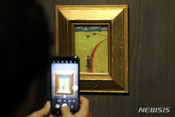 [서울=뉴시스] 박진희 기자 = '자화상'(1951) 작품. 6.25전쟁 이후 임시수도인 부산에서 피난살이를 하던 장욱진이 종군화가로 복무 중에 잠시 고향인 충남 연기군(지금의 세종시)에서 머물던 시기 그린 작품이다. 그는 이 시기 방황에서 잠시 안정을 찾으니 작품 의욕이 솟아 “미친 듯이 그리고 또 그렸다”고 전한다. 한 뼘 크기의 작은 종이 위에 유화 물감으로 그려진 '자화상'은 누렇게 황금 물결을 이룬 벼 이삭과 기찻길처럼 하염없이 펼쳐진 붉은 황토색의 논두렁 사이로 콧수염을 기른 모던한 모습의 장욱진이 걸어오고 있다. 결혼식 때 입은 하이칼라 프록코트 차림으로 귀향 중인 그를 따라 동네를 서성이던 검둥개와 새들이 뒤따른다. 노년기에 등장하는 서너 마리가 일렬로 줄지어 나는 새들의 비행 도상도 이 작품에 처음 등장한다. 2023.09.29. pak7130@newsis.com