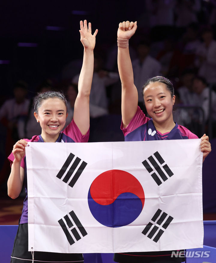 [항저우=뉴시스] 고승민 기자 = 2일 중국 항저우 공슈 캐널 스포츠파크 짐내시움에서 열린 2022 항저우 아시안게임 여자 탁구 복식 결승 한국 대 북한 경기, 세트스코어 4:1로 북한에 승리를 거두고 금메달을 획득한 전지희, 신유빈이 태극기를 들고 기뻐하고 있다. 2023.10.02. kkssmm99@newsis.com