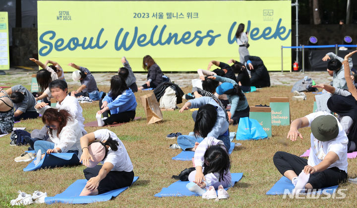 [서울=뉴시스] 최진석 기자 = 7일 서울 성동구 서울숲에서 열린 ‘2023 서울 웰니스 위크(Seoul Wellness Week)’에서 참가자들이 요가 플래시몹을 하고 있다. 2023.10.07. myjs@newsis.com