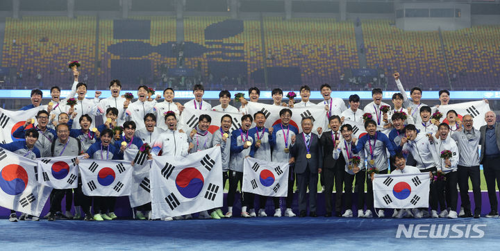 [항저우=뉴시스] 고승민 기자 = 7일 중국 항저우 황룽스포츠센터 스타디움에서 열린 2022 항저우 아시안게임 남자 축구 결승 한국 대 일본 경기, 일본을 2대1로 꺾고 금메달을 차지한 한국 선수들이 이기흥 대한체육회장, 정몽규 대한축구협회장, 황선홍 감독 등과 기념촬영하고 있다. 2023.10.08. kkssmm99@newsis.com