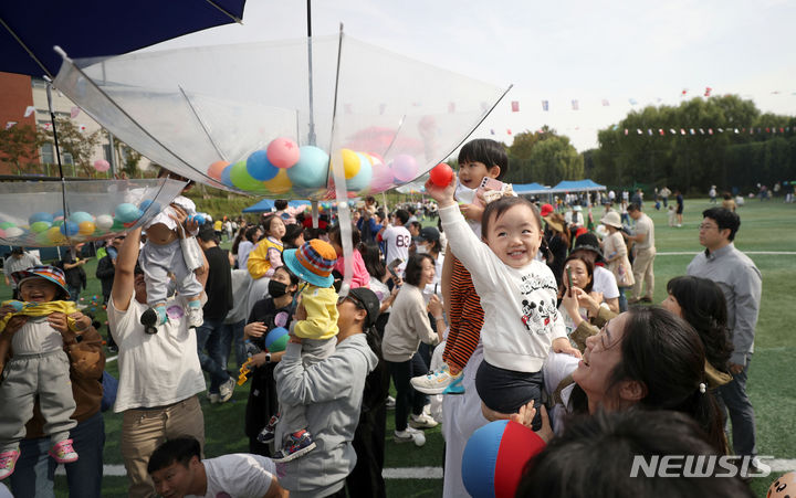 [서울=뉴시스] 김선웅 기자 = 13일 서울 송파여성축구장에서 열린 송파구 주최·송파구가정어린이집연합회 주관 '아기새들의 놀이한마당' 가을운동회에서 참여 어린이들과 학부모, 보육 교직원들이 공던지기 경기를 하고 있다. 2023.10.13. mangusta@newsis.com