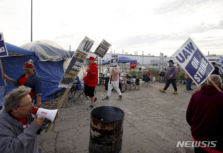 [톨레도( 미 오하이오주)=AP/뉴시스]미 자동차 노조 연합의 오하이오 공장 파업에 참가한 노동자들이 10월 26일 회사 조립공장 앞에서 파업을 벌이며 행진하고 있다. 2023.10.29. 