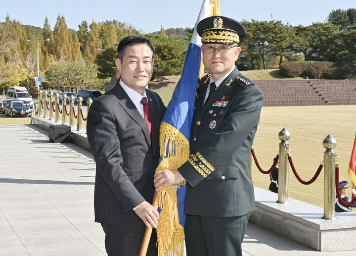 [서울=뉴시스] 박안수 신임 육군참모총장이 신원식 국방부 장관으로부터 부대기를 받고 있다.(사진=육군 제공) 2023.10.31. photo@newsis.com *재판매 및 DB 금지