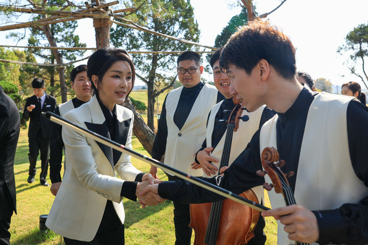 [서울=뉴시스] 윤석열 대통령 부인 김건희 여사가 2일 서울 용산구 대통령실 파인그라스에서 열린 ‘발달장애 예술인과 함께하는 요요마 토크콘서트’에서 연주자들을 격려하고 있다. (사진=대통령실 제공) 2023.11.02. photo@newsis.com *재판매 및 DB 금지