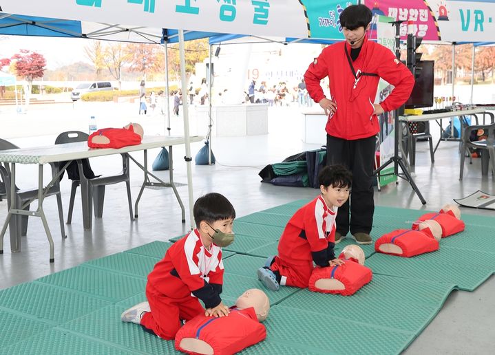 [충주=뉴시스] 이도근 기자= 2023 충주시 재난안전체험마당이 열린 3일 충북 충주시 탄금공원 안전체험 부스에서 어린이들이 심폐소생술 체험을 하고 있다. (사진=충주시 제공) 2023.11.3. photo@newsis.com *재판매 및 DB 금지