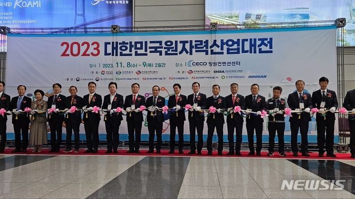 [창원=뉴시스]홍정명 기자= 8일 오전 경남 창원컨벤션센터에서 열린 ‘2023 대한민국 원자력산업대전’ 개막식 참석자들이 개막 기념 테이프를 자르고 있다.(사진=경남도 제공) 2023.11.08. photo@newsis.com