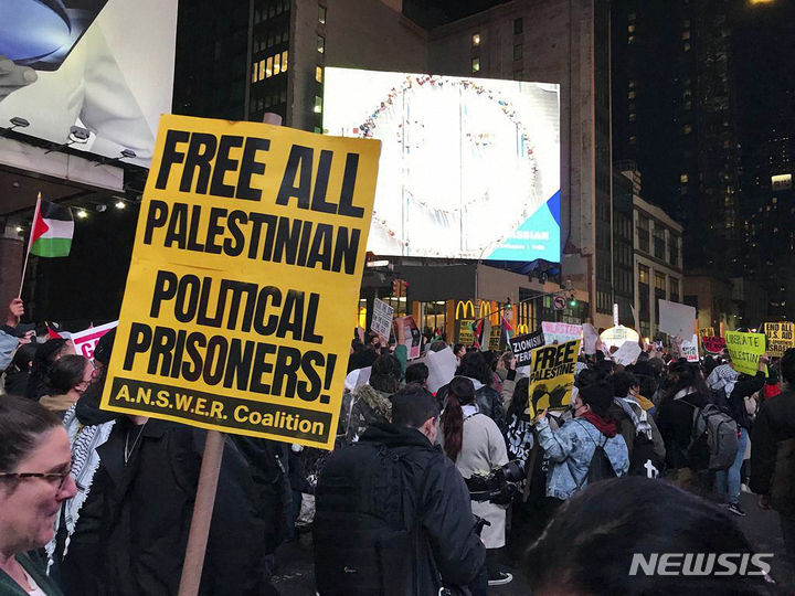 [뉴욕=AP/뉴시스] 9일(현지시각) 미국 뉴욕의 뉴욕 타임스(NYT) 앞에서 친팔레스타인 시위대가 손팻말을 들고 시위하고 있다. 이스라엘은 지난달 7일 프리랜서 사진가들이 하마스의 기습 정보를 미리 입수했고, 일부는 하마스와 내통했다는 의혹을 제기하면서 이들로부터 사진을 받아 보도한 NYT 등 미국 유력 언론사들을 비난했다. NYT는 사전 정보 입수에 관한 의혹을 강력히 부인하며 "이스라엘의 터무니 없는 주장으로 이스라엘과 가자지구 현장의 기자들을 위험에 빠뜨렸다"라고 반박했다. 2023.11.10.