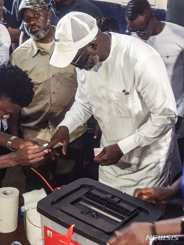 [몬로비아=AP/뉴시스]프로축구 선수 출신 조지 웨아 라이베리아 대통령이 지난 14일(현지시간) 실시된 대통령 선거에서 투표하고 있다. 그는 17일 대선 패배를 인정했다. 2023.11.18.