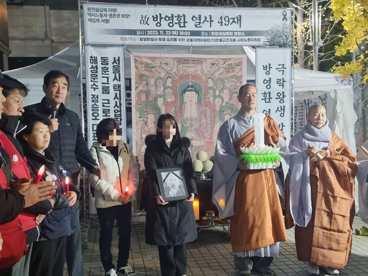 [서울=뉴시스] 23일 오후 고인이 안치된 서울 영등포구 한강성심병원 앞에서 분신 택시노동자 고(故) 방영환씨의 49재와 투쟁문화제가 열렸다. 사진은 고인의 영정사진을 안고 있는 딸 방희원씨. 2023.11.23. photo@newsis.com *재판매 및 DB 금지