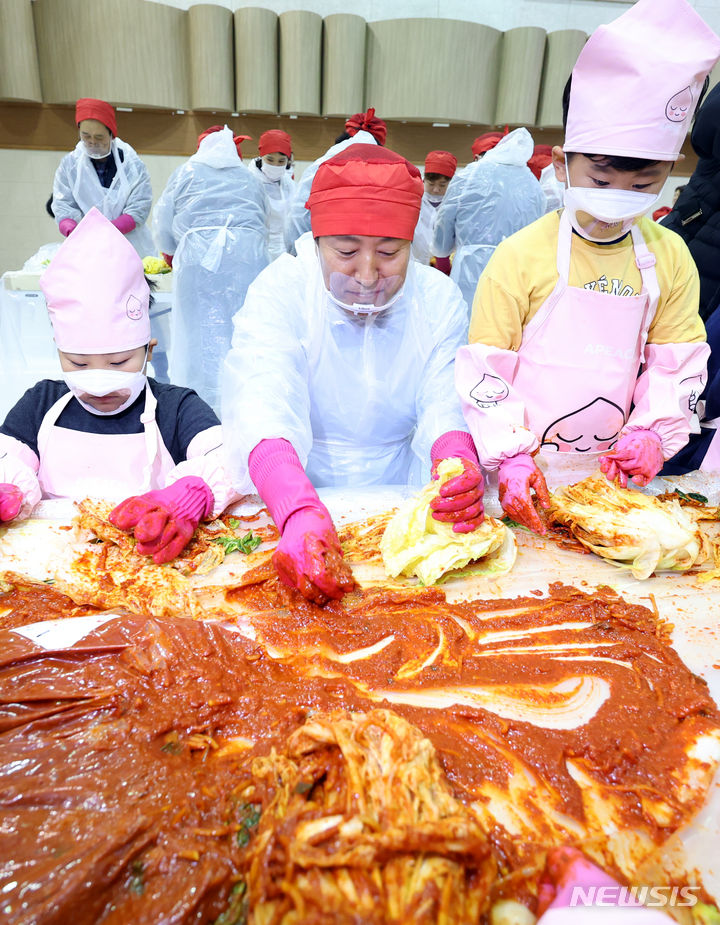 [서울=뉴시스] 최진석 기자 = 오세훈 서울시장이 27일 서울 중구구민회관에서 열린 국민대통합 김장나눔 행사에서 어린이들과 김치를 담그고 있다. 2023.11.27. myjs@newsis.com