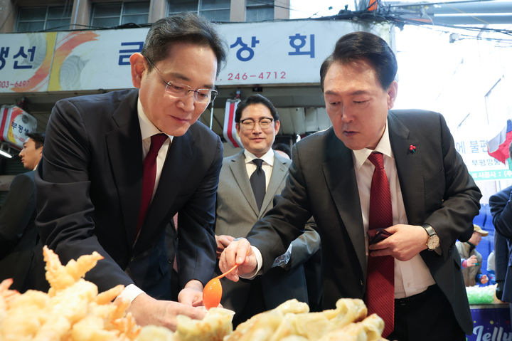 [부산=뉴시스] 윤석열 대통령이 6일 부산 중구 깡통시장을 방문해 이재용 삼성전자 회장과 떡볶이 등 분식을 맛보고 있다. (사진=대통령실 제공) 2023.12.06. photo@newsis.com *재판매 및 DB 금지