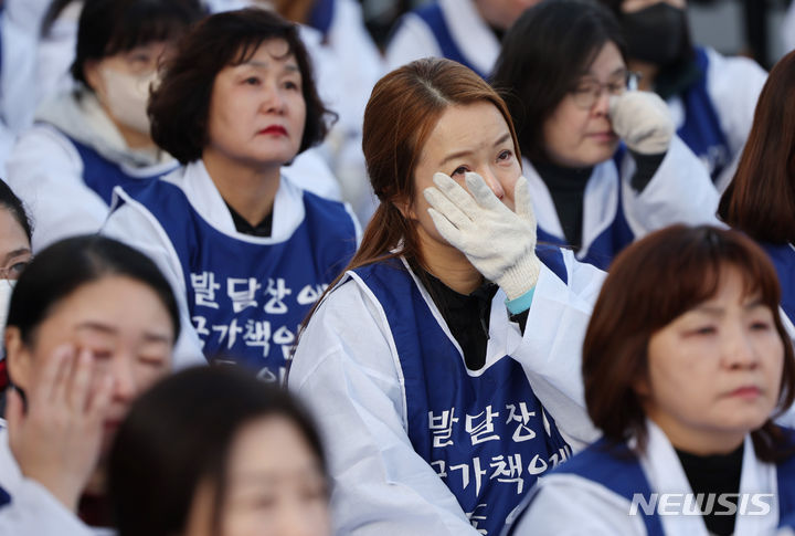 [서울=뉴시스] 김진아 기자 = 전국장애인부모연대, 서울장애인부모연대 관계자들이 7일 서울 종로구 정부서울청사 앞에서 열린 전국 오체투지 보고대회 및 서울 오체투지 선포식에서 전국 오체투지 활동 영상을 보며 눈물을 흘리고 있다. 이들은 '차별없는 세상, 완전한 통합사회 구축'이라는 슬로건 아래, 발달장애인이 자립 생활할 권리, 통합교육을 받을 권리, 노동할 권리 등을 촉구하며 제주에서 서울까지 전국 각지에서 오체투지 행진을 진행했다. 2023.12.07. bluesoda@newsis.com