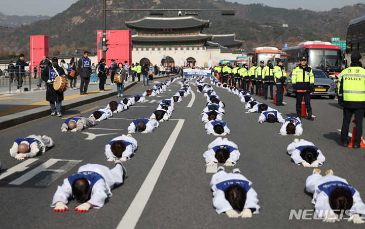 [서울=뉴시스] 김진아 기자 = 서울장애인부모연대 관계자들이 7일 서울 종로구 정부서울청사 앞에서 열린 전국 오체투지 보고대회 및 서울 오체투지 선포식을 마친 후 서울시청으로 오체투지 행진을 하고 있다. 전국장애인부모연대는 '차별없는 세상, 완전한 통합사회 구축'이라는 슬로건 아래, 발달장애인이 자립 생활할 권리, 통합교육을 받을 권리, 노동할 권리 등을 촉구하며 제주에서 서울까지 전국 각지에서 오체투지 행진을 진행했다. 2023.12.07. bluesoda@newsis.com