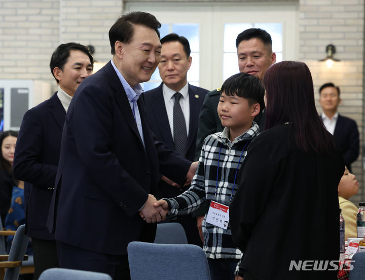 [서울=뉴시스] 조수정 기자 = 윤석열 대통령이 22일 서울 용산 대통령실 청사에서 열린 '히어로즈 패밀리와 함께하는 꿈과 희망의 크리스마스' 행사에서 입장하며 초청 순직 군인·경찰·소방관 자녀와 인사나누고 있다. 2023.12.22. chocrystal@newsis.com