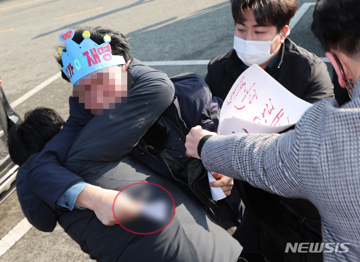 [부산=뉴시스] 하경민 기자 = 지난 1월2일 오전 부산 강서구 대항전망대에서 이재명 더불어민주당 대표를 흉기로 피습한 옹의자가 흉기를 든 채 경찰에 제압되고 있다. 2024.01.02. yulnetphoto@newsis.com