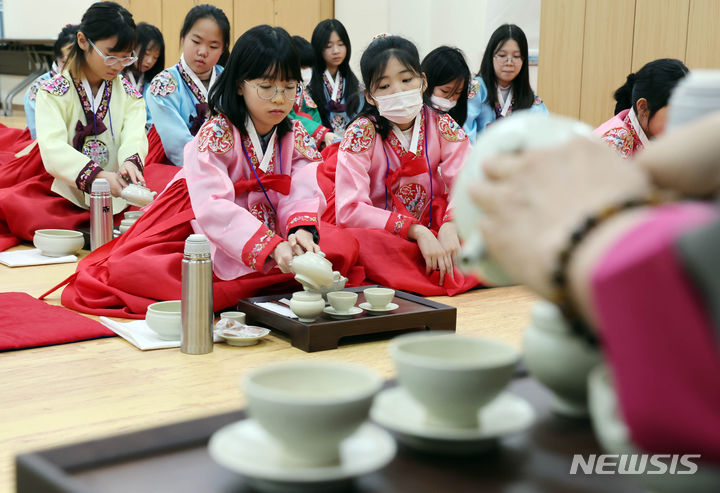 [부산=뉴시스] 하경민 기자 = 8일 오전 부산 동래구 충렬사 안락서원 교육회관에서 열린 '초등학생 겨울방학 전통문화 체험교실'에 참가한 초등생들이 한복을 곱게 차려입고 다도 예절을 배우고 있다. 초등학생 40여 명이 참가한 이번 체험교실에서는 다도 및 서당 체험과 민요 배우기, 민속놀이 체험 등을 오는 12일까지 진행한다. 2024.01.08. yulnetphoto@newsis.com