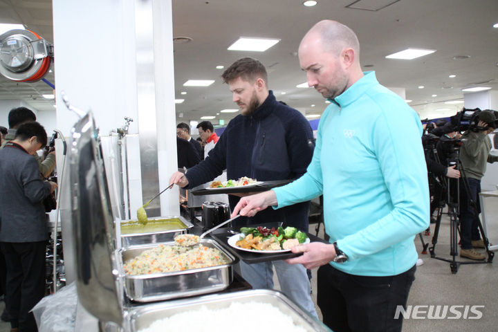 [강릉=뉴시스] 이순철 기자 = 지난 1월 10일 강릉원주대학교 율곡관에서 열린 2024 강원동계청소년올림픽 선수촌 식단 사전 시식행사에 참여한 외국인이 접시에 음식을 담고 있다. 2024.1.10. grsoon815@newsis.com