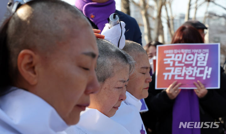 [서울=뉴시스] 최진석 기자 = 10.29 이태원 참사 유가족들이 18일 서울 용산 대통령실 앞에서 국민의힘 거부권 행사 건의에 대한 규탄 입장을 표명하는 삭발식을 하고 있다. 2024.01.18. myjs@newsis.com